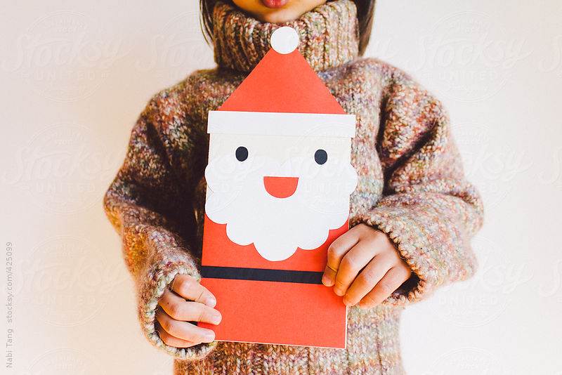 A boy holding big Santa Claus card by Nabi Tang
