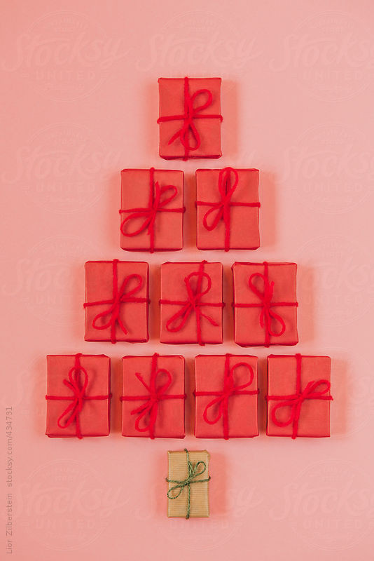 Simple gifts shaped like Christmas tree on pink background by Lior Zilberstein