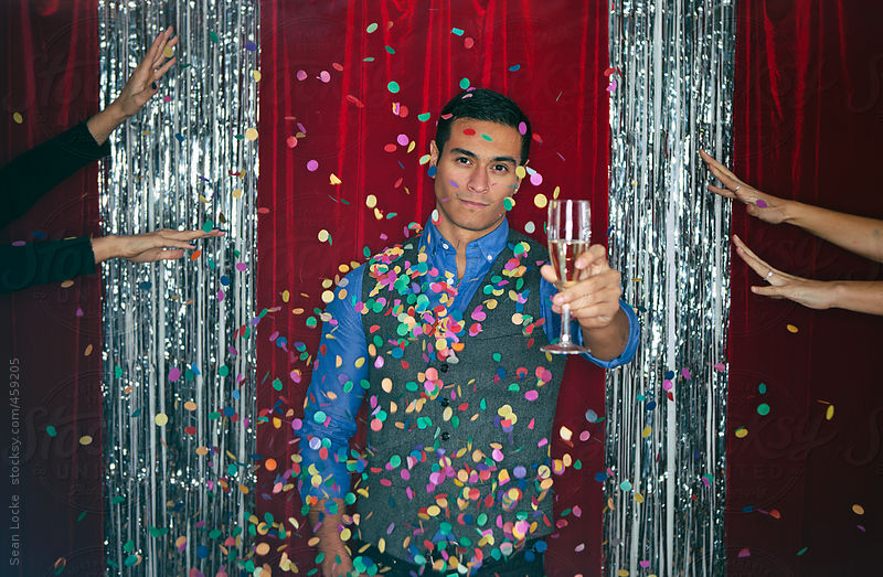 Party: Man With Champagne Looks Serious At Women Throw Confetti by Sean Locke