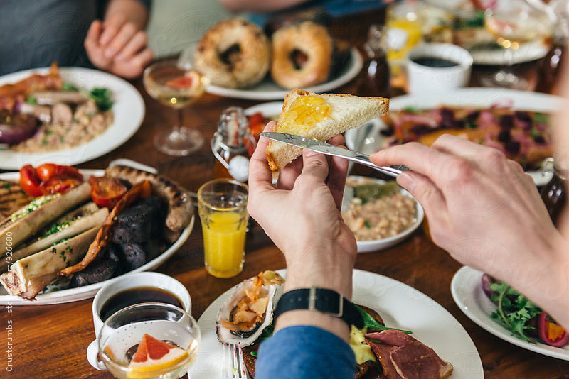 Man spreading marmelade on bread by Crustcrumbs