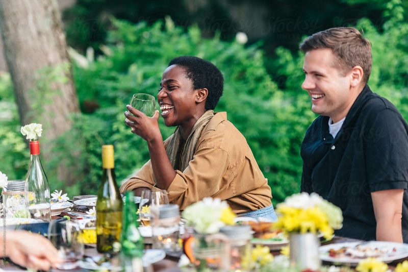 Stock photo of friends enjoying a summer feast