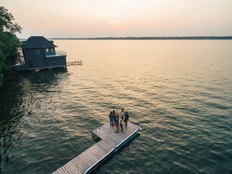 Friends Doing A Toast On The Dock At Sunset